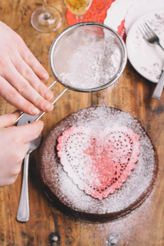 Use a doily to decorate this Flourless Chocolate Cake • theVintageMixer.com Flourless Chocolate Cake Recipe