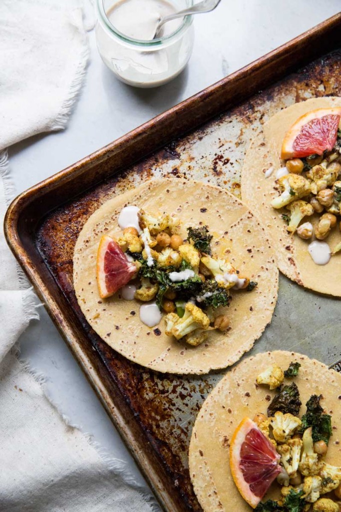 Cauliflower Chickpea and Crispy Kale Tacos with Orange Tahini Sauce • theVintageMixer.com #tacos #vegetariantacos #vegetarianrecipe #veganrecipe #glutenfreerecipe