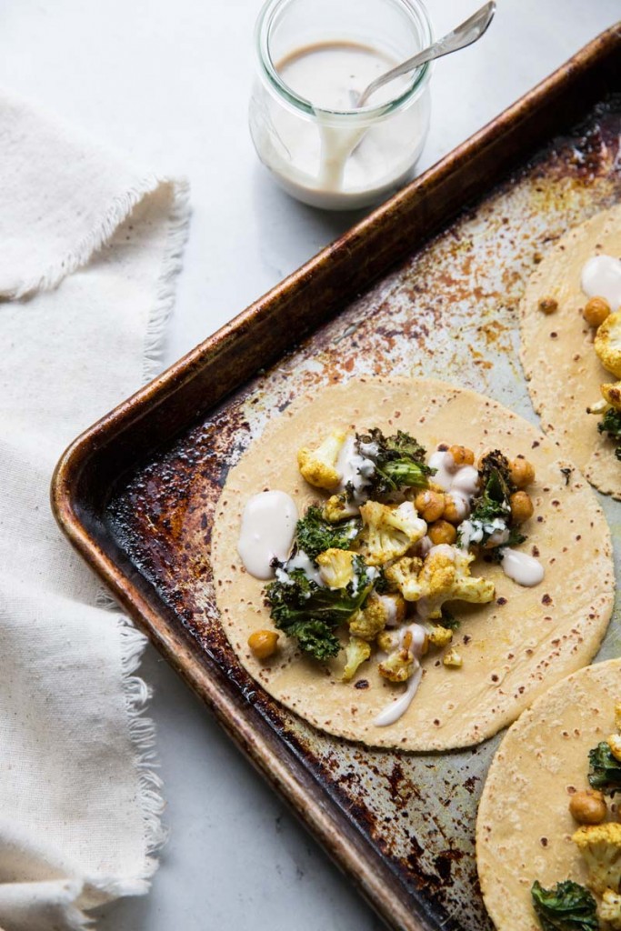 Cauliflower Chickpea and Crispy Kale Tacos with Orange Tahini Sauce • theVintageMixer.com #tacos #vegetariantacos #vegetarianrecipe #veganrecipe #glutenfreerecipe