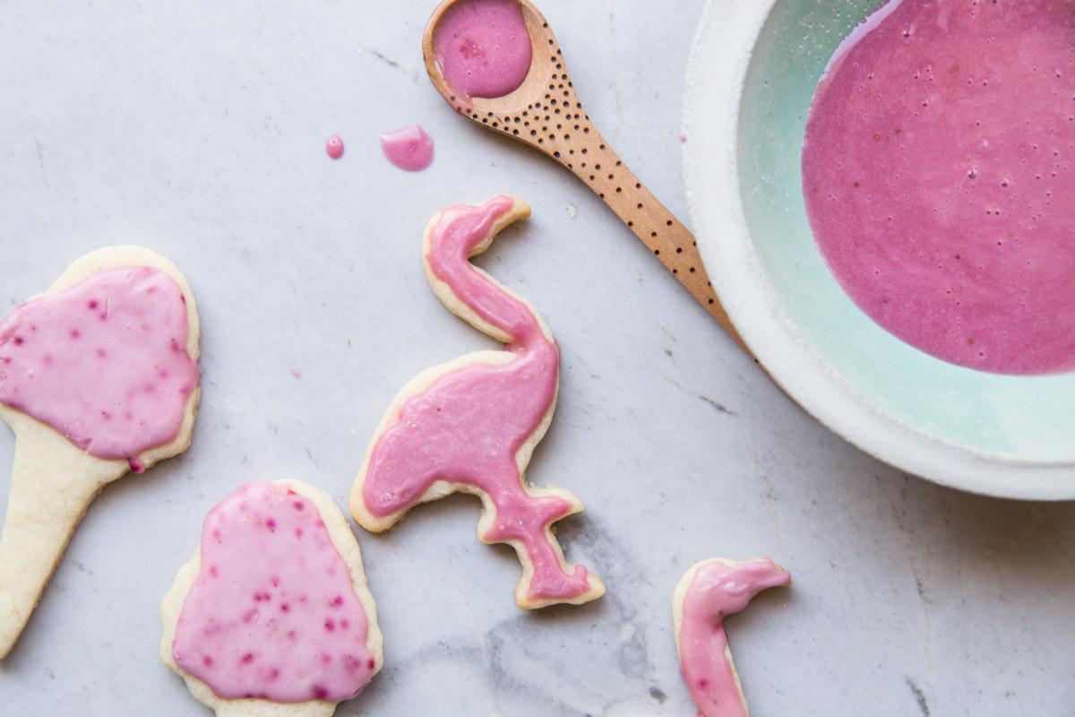 How cute are these flamingo and ice cream cone cut out cookies. This is a fail proof cut out cookie recipe and a delicious icing made with all natural flavors and food coloring.