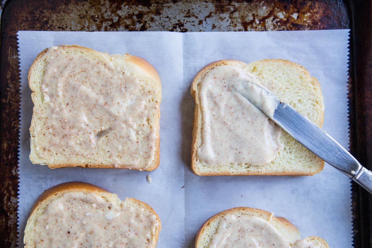 Spreading almond frangipane on brioche bread