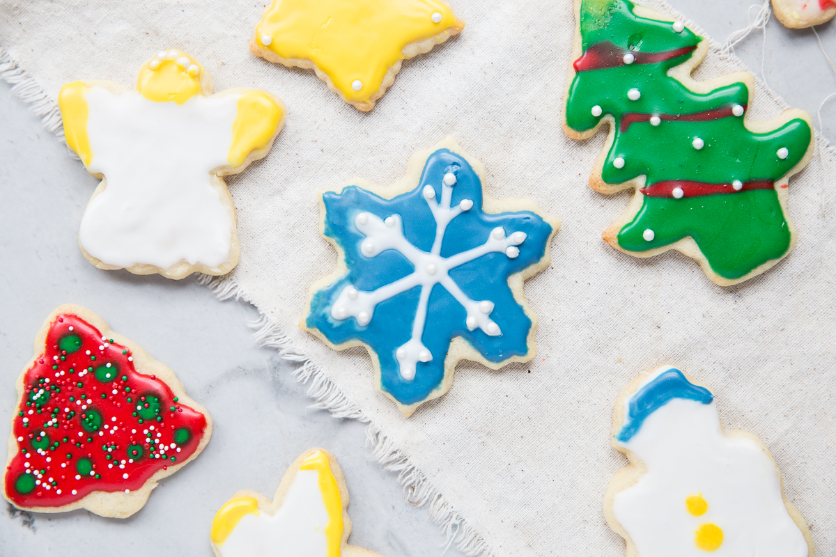 This is the BEST recipe for Christmas Cut Out Sugar Cookies! They don't spread when you bake them and the frosting dries flat. 